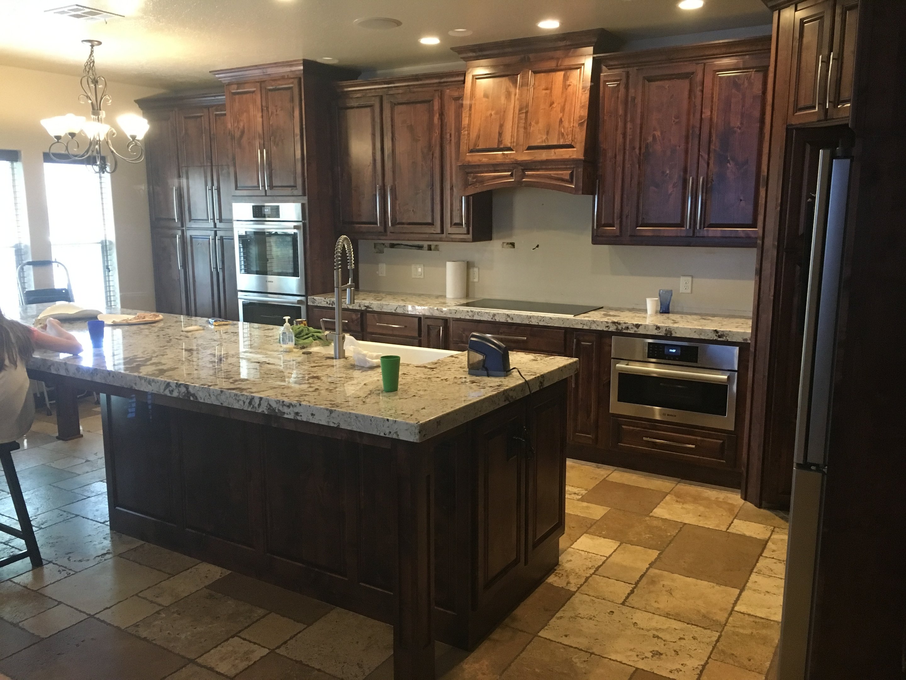 Dark wood kitchen with large island and custom cabinets