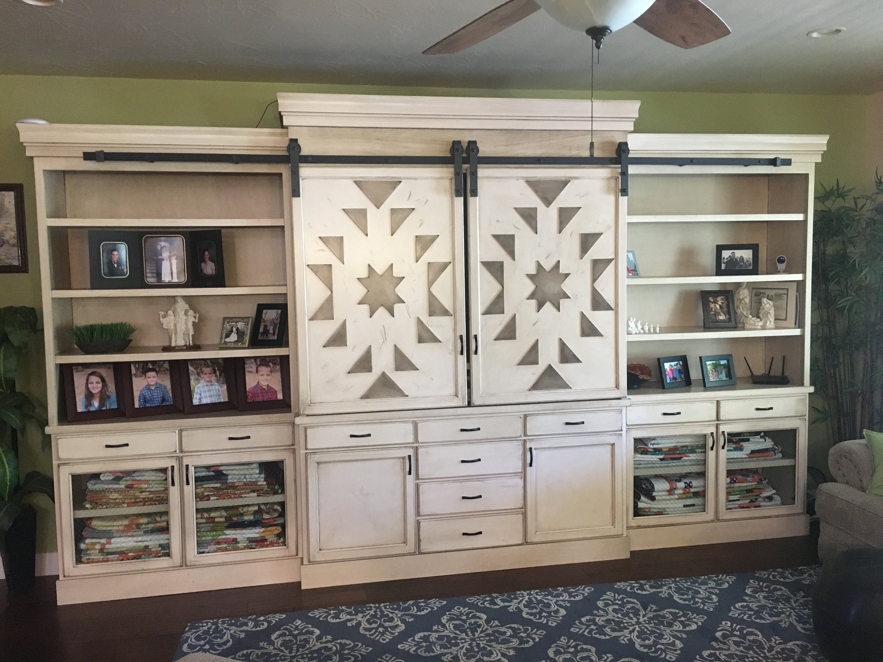 Painted built-in wall storage with sliding barn-style doors